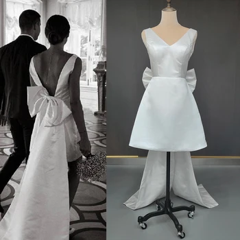 Кратко мини-атласное сватбена рокля с V-образно деколте и голям лък, сшитое на поръчката, плюс размера на отворена облегалка, директна доставка на сватбена рокля с дължина над коляното